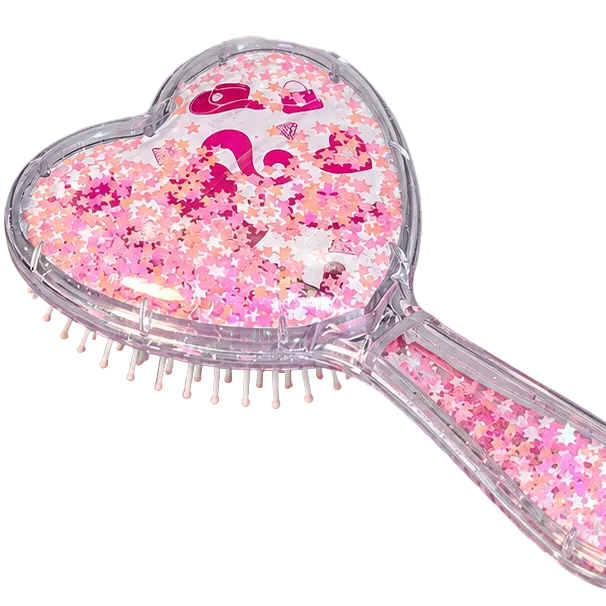 A heart-shaped handheld hairbrush filled with pink glitter and small star-shaped confetti